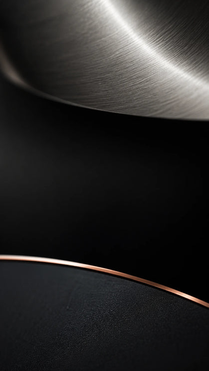 Vertical macro close-up of brushed metal curve with rose gold edge